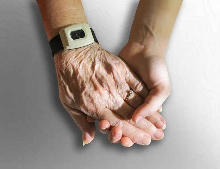 two hands holding each other